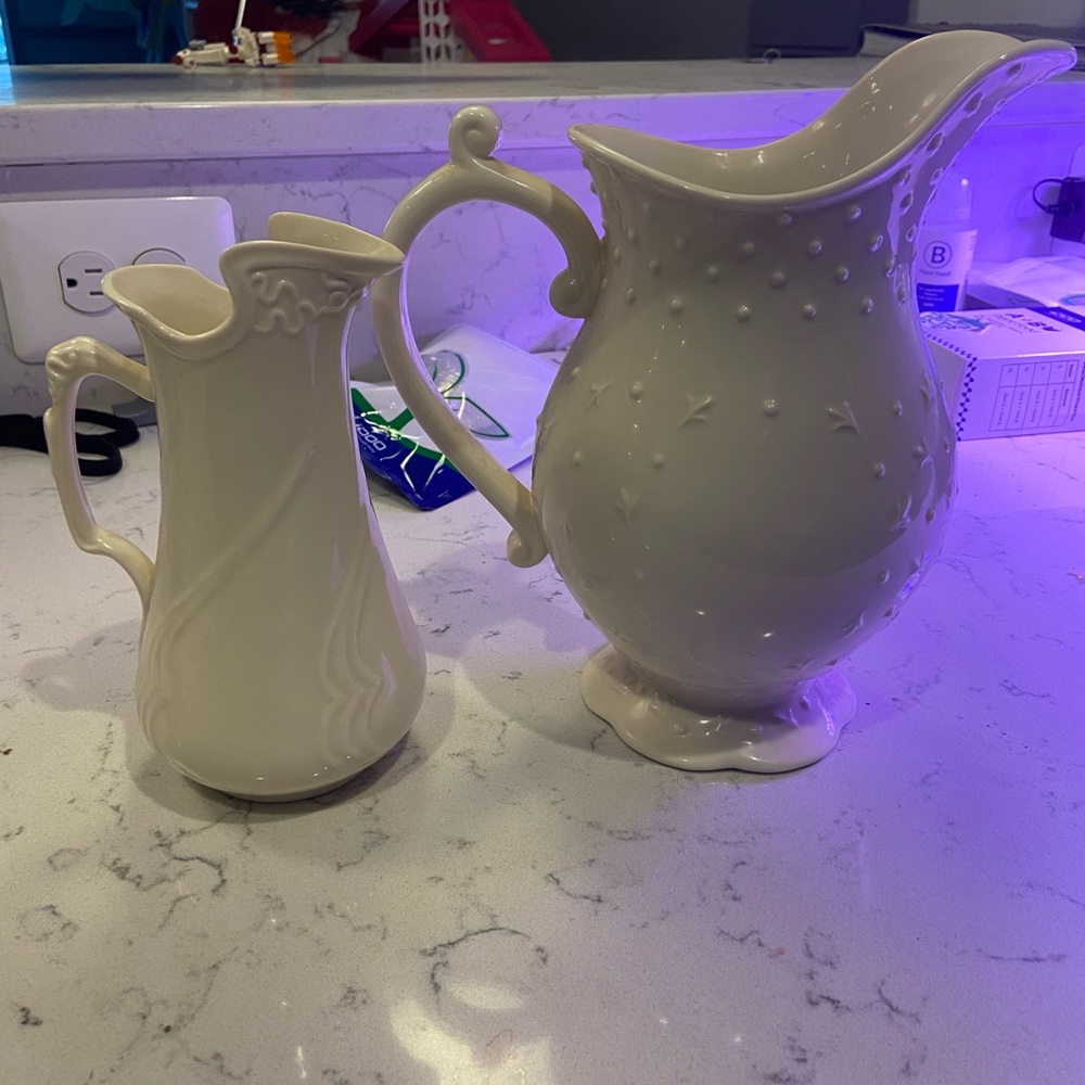 2 cream colored porcelain pitchers